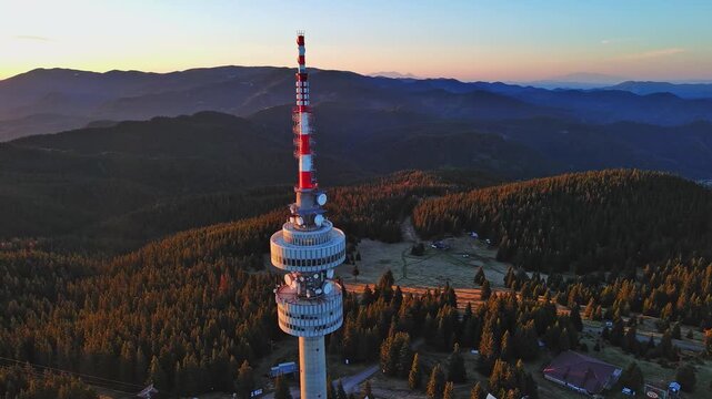 Tower Snezhana on peak of Snezhana covered with spruce forests in Rhodope mountains