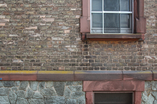 Brick and stone facade - window and weathered texture