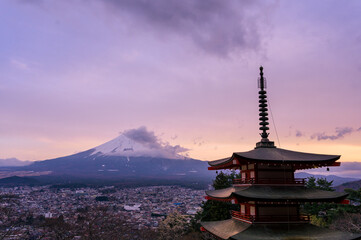 Scenic view of Mount Fuji and Chureito Pagoda at sunset, showcasing Japan’s iconic landscape and traditional architecture in harmony with nature.
