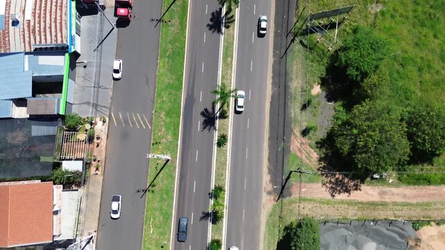 Top down aerial view of cars driving on a busy highway in Brazil. Highway transportation infrastructure, asphalt road, speed and modern traffic pattern from above.