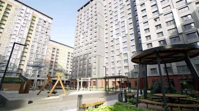 Residential development features multifunctional courtyard with integrated play areas. Recreational zone includes swings and cozy pavilions
