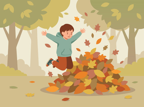 Boy jumping into a pile of autumn leaves.