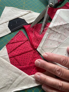 Close-up of Japanese Foundation Paper Piecing (FPP) Quilting with Cotton Fabric and Scissors and some paper pattern samples