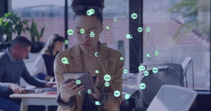 Woman holding tablet tapping in open business office, reviewing orders, making icons cluster