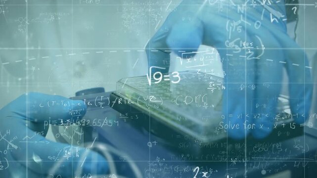 Lab technician hand holding reader while right hand aligning green plate for test, equations rising