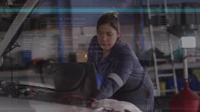 Female technician connecting laptop and diagnosing engine in auto shop, terminal overlay updating