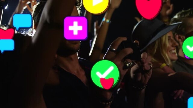 Fans holding phones recording show stage flashes sparking icons spreading over concert hiding faces