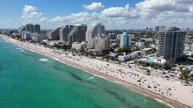 Spring breakers enjoying a sunny beach day at Fort Lauderdale Beach in Broward County, Florida.
