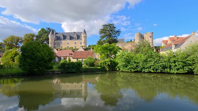 Picturesque village of Montresor in the Loire Valley of France. Slow panning motion. Chateau with reflections in the Indrois River.