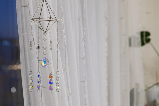 Hanging geometric crystal prism suncatcher with iridescent beads and fairy lights
