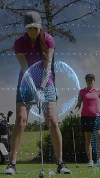 Golfer addressing ball, executing full swing for golf practice while AR sphere tracking club path