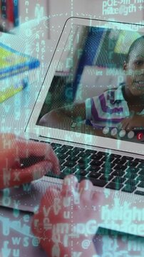 Vertical video: Hands typing as onscreen teen talking, driving globe and code overlay for learning