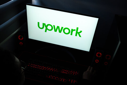 Punta Arenas, Chile &ndash; March 29, 2026: A desktop computer monitor in a dark room displaying the Upwork logo, the freelancing platform for connecting businesses and independent professionals