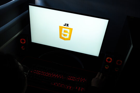 Punta Arenas, Chile &ndash; March 29, 2026: A desktop computer monitor in a dark room displaying the JavaScript logo, representing the essential programming language for web development