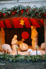 Fototapeta premium Wooden nativity scene with figures and sheep decoration