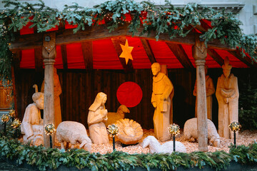 Fototapeta premium Wooden nativity scene display with figures and sheep