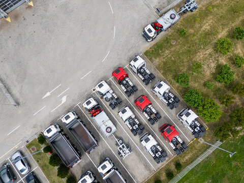 Aerial view of a large fleet of new commercial trucks at a dealership