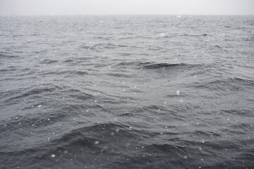 Fototapeta premium Königssee lake with gentle waves and falling snow