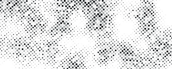 Naklejka premium A dense abstract pattern of uniformly sized gray dots covers the majority of this black and white image