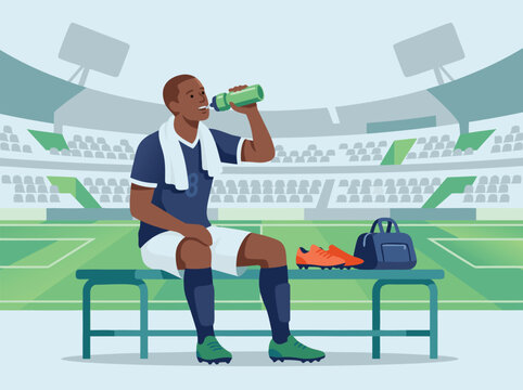 Soccer Player Resting on Bench with Water Bottle.