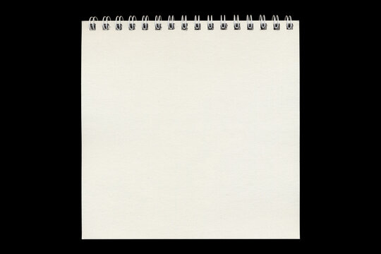 Blank spiral notepad sheet in vertical format on black background