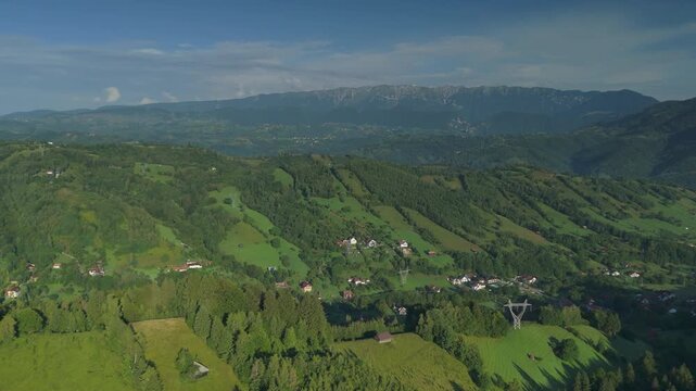 High altitude aerial of vast high-voltage transmission lines and towers over the Bran Simon hills, Carpathian Mountains Transylvania Romania, essential power grid