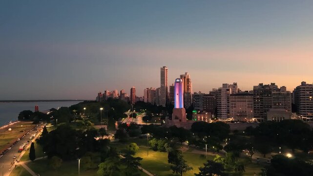 Aerial view of the National Flag Memorial in Rosario, Argentina, with the Paran&aacute; River and city skyline at sunset
