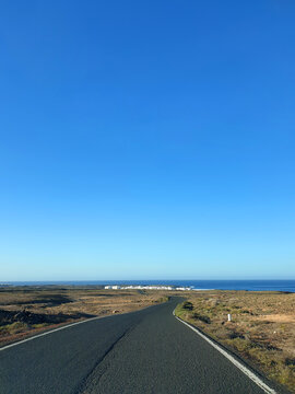 Coastal road leading to the coastal village Caleta de Caballo, Island Lanzarote, Canary Islands, Spain, Europe.