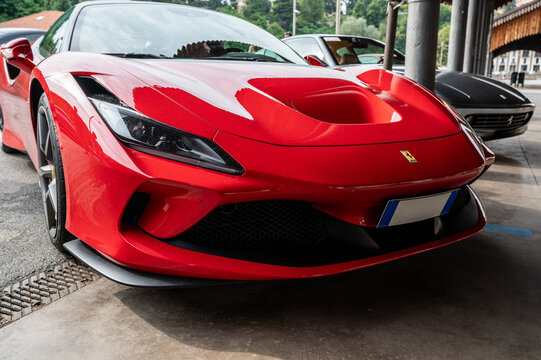 Mondov&igrave; (cuneo), italy, july 21, 2024. Ferrari rally. Red ferrari f8 tributo sports car showcasing its sleek design and performance styling, parked outdoors on a sunny day