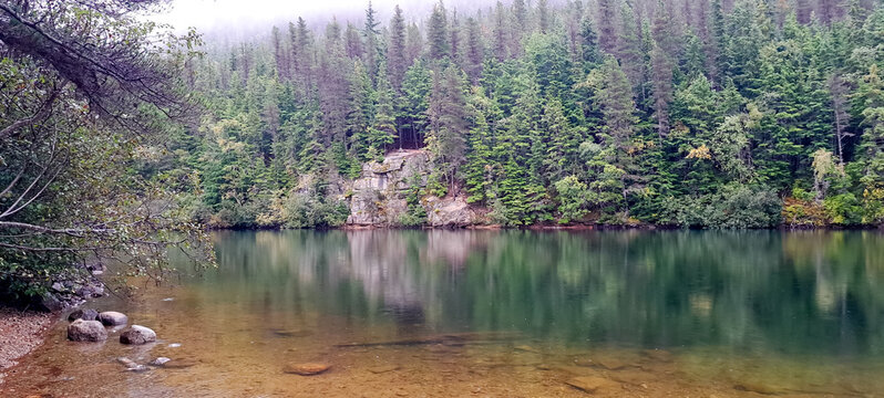 Sturgills landing, Devils punchbowl, Alaska a beautiful landscape enjoyed by tourists and hikers as they enjoy the towering cliffs and majestic forests surrounding the lake.