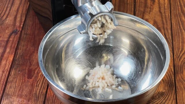 Starting grinding cod into ground fish with electric meat grinder