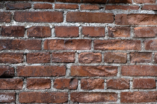 Close up of an aged clay brick wall background