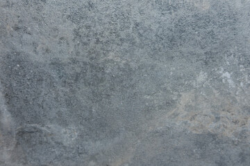 Fototapeta premium Textured surface of gray stone with natural variations and subtle shadow patterns