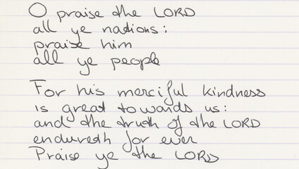 Fototapeta premium Handwritten text on lined notepaper contains the Psalm 117 from the Book of Psalms in the OldTestament, written in English. 