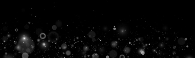 Falling silver glitter sparkles drift softly across a dark scene. Tiny particles shimmer like stars in motion. Perfect overlay for holiday, magical, and festive designs. © goldstock
