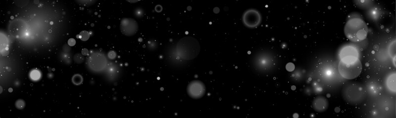 Falling silver dust sparkles create a magical luminous effect. Tiny particles drift softly across a dark transparent background. Perfect overlay for festive and holiday designs. © goldstock