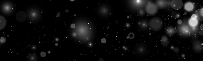 Falling white glitter sparkles drift softly across a dark scene. Tiny particles shimmer like tiny lights. Perfect overlay for Christmas, New Year, and magical designs. © goldstock