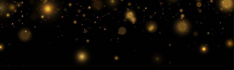 Golden dust sparkles drift softly in abstract motion. Light particles shimmer like tiny stars. Perfect overlay for holiday, magical, and festive designs. © goldstock