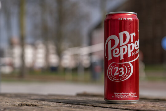 Dr Pepper can on wooden surface in park setting, editorial use