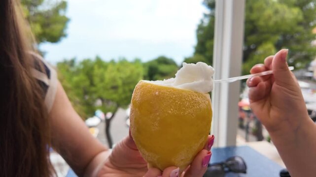Refreshing Italian lemon sorbet served in natural fruit peel in Italy