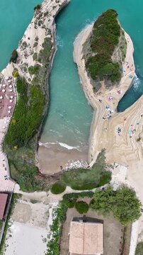 Cinematic 4K footage of Sidari's Canal d'Amour, Corfu, Greece. Incredible natural architecture of eroded sandstone rocks, blue Ionian sea, and relaxing vacation atmosphere at the legendary beach.
