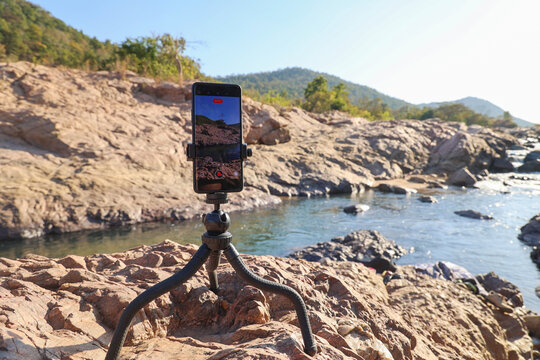 Smartphone on Tripod Recording Scenic Mountain River Landscape in Natural Rocky Terrain