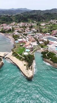 Luxury travel destination in Greece: Canal d'Amour in Sidari, Corfu. High-quality landscape featuring famous love canal, layered rock formations, sea caves, and pristine blue water for tourist catalog