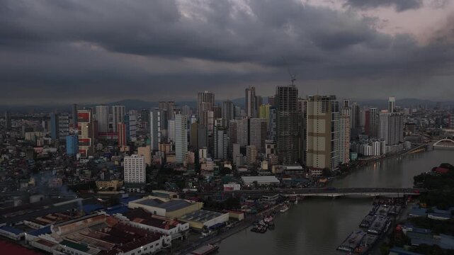 Stormy ominous dark clouds moving over manila cityscape