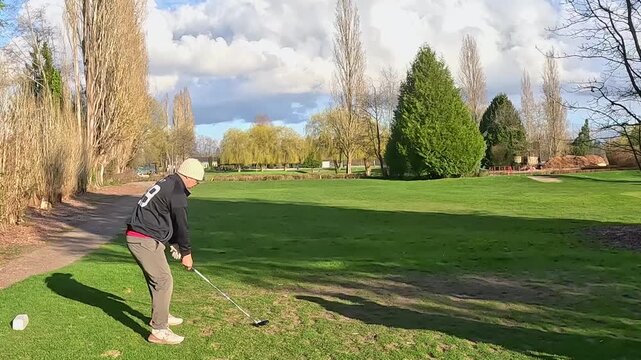 asian man in white tuque hitting a wood in spring