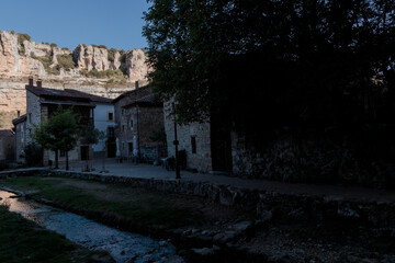 Orbaneja del castillo village with limestone cliffs and stream © larrui