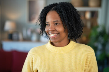 Fototapeta premium Young black woman smiling looking away with happiness