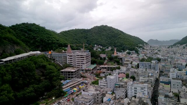 Aerial city view of Vijayawada and Kanaka Durga Temple on a cloudy day