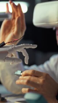 In a modern workspace, an engineer dons a virtual reality headset and carefully assembles a robotic hand, blending cutting-edge technology with creative design, showcasing innovative engineering