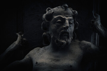 Fototapeta premium Dark statue inspired by Sisyphus myth, symbolizing endless struggle, burden, and human perseverance in a dramatic and shadowy underworld atmosphere.